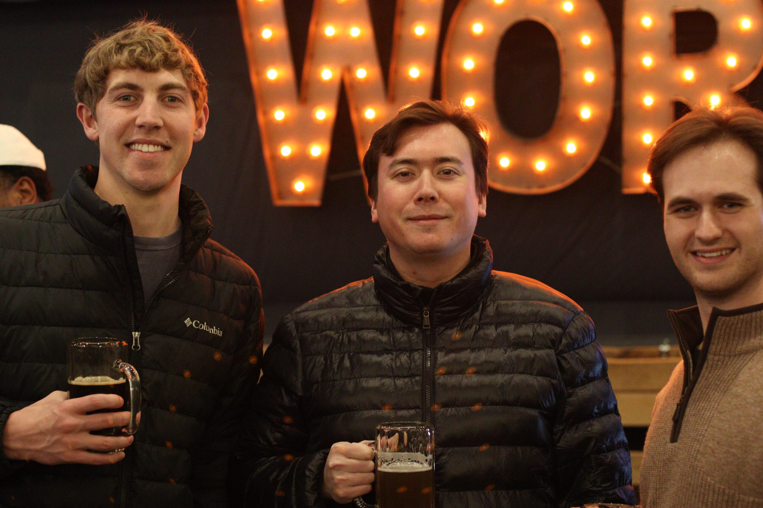 Two men holding mugs of beer.