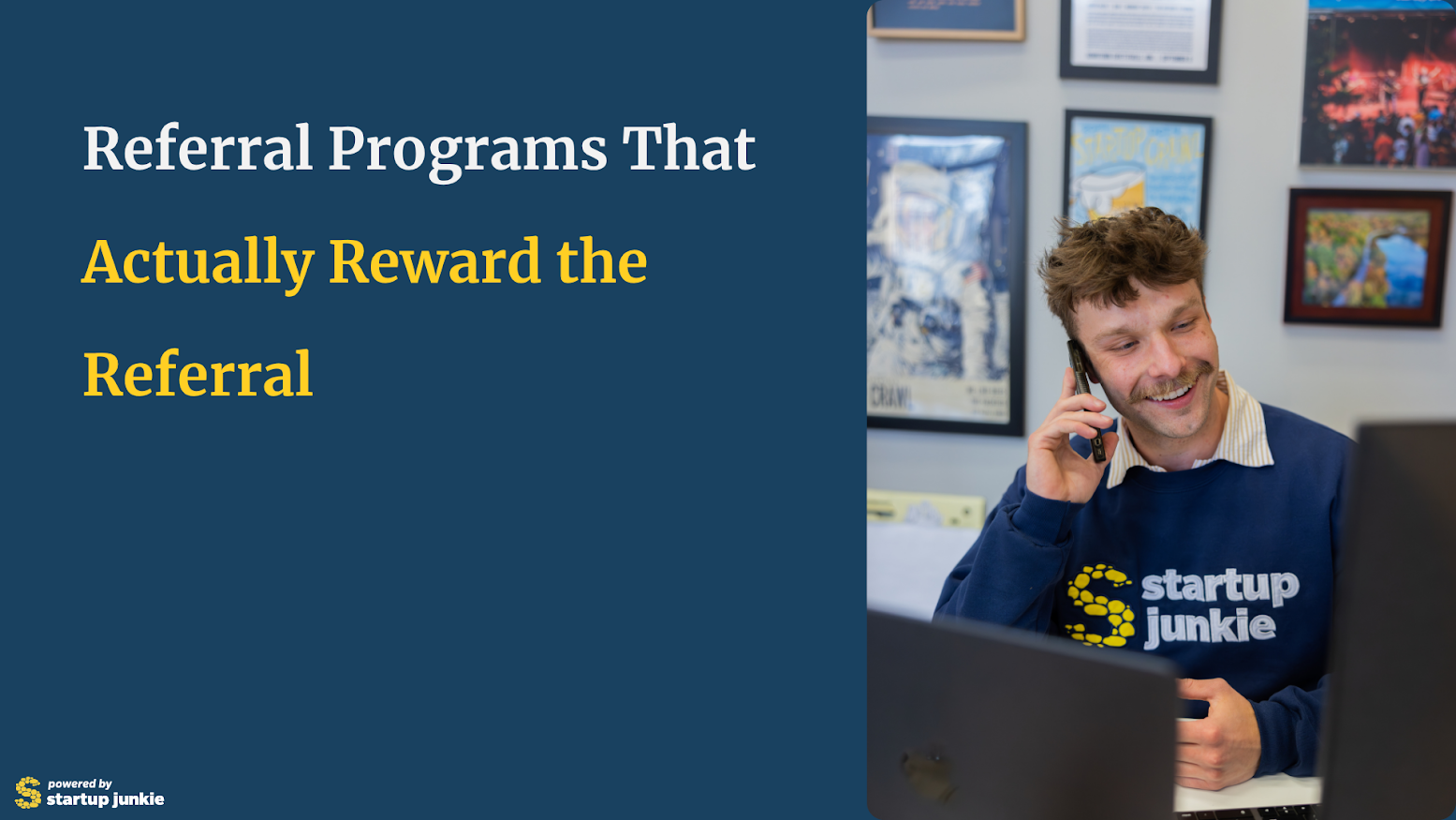 A man in a startup junkie sweatshirt talks on the phone at his desk. Text on the left reads, Referral Programs That Actually Reward the Referral. Startup Junkie logo is in the corner.