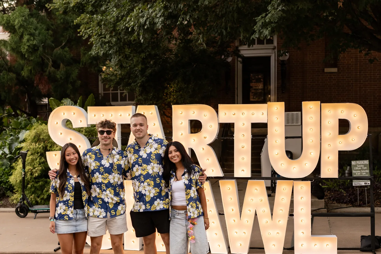 Friends gather in front of the Startup Crawl marquee, 2026