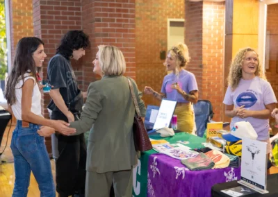 Women network at a booth during Startup Crawl 2026