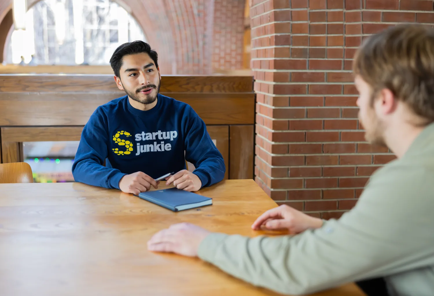 Startup Junkie team collaborates around the table