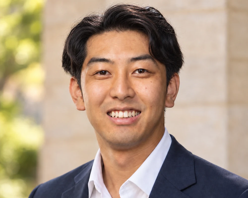 Toma Tomonari, Senior Consultant, Japan Programs at Startup Junkie Consulting, smiling in a navy blazer